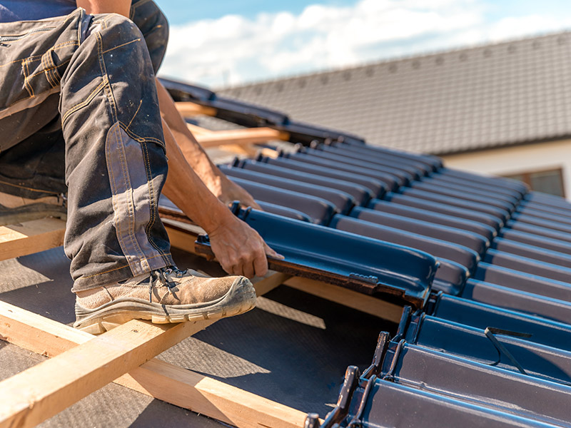 Services 19 roofer laying asphalt shingles on a house roof 2026 03 17 05 04 37 utc