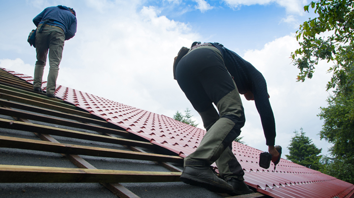 construction workers install red roofing on a buil 2026 03 19 10 38 18 utc